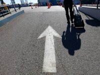 1008280152 ma nb NantucketFerry  A passenger makes his way to catch the maiden voyage of the Seastreak Whaling City Express ferry service from New Bedford State Pier  to Nantucket.   PETER PEREIRA/THE STANDARD-TIMES/SCMG : ferry, waterfront, voyage, trip, harbor